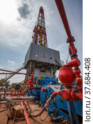 Uralsk region, Kazakhstan - May 24 2012: Oil deposit Zhaikmunai. Mud pump for drilling rig. Sky with clouds background. Стоковое фото, фотограф Alexey Rezvykh / Фотобанк Лори