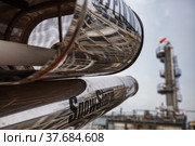 Uralsk region, Kazakhstan - May 24 2012: Oil deposit Zhaikmunai. Oil refinery plant safety technologies. Fire extinguisher. Distillation tower blurred on background. Редакционное фото, фотограф Alexey Rezvykh / Фотобанк Лори