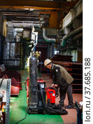 Ekibastuz, Pavlodar region, Kazakhstan - May 28, 2012: Rail car-building plant. Welder worker with oxy acetylene welding set. Редакционное фото, фотограф Alexey Rezvykh / Фотобанк Лори