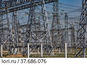 Electric transformer substation. Distribution station of electricity. On blue sky background. Стоковое фото, фотограф Alexey Rezvykh / Фотобанк Лори