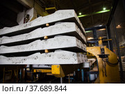 Temirtau, Kazakhstan - June 09, 2012: Concrete sleepers manufacturing plant NORD Prom NS. Stack of ready sleepers in workshop. No people. Стоковое фото, фотограф Alexey Rezvykh / Фотобанк Лори