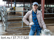 Female farmer standing near cowshed at dairy farm with milk churn. Стоковое фото, фотограф Яков Филимонов / Фотобанк Лори