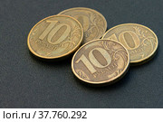 На столе лежат несколько российских десятирублевых монет. Российский рубль. Стоковое фото, фотограф Виталий Михайлюк / Фотобанк Лори