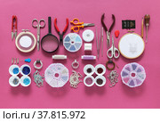 DIY concept. Top view on tools and accessories for embroidery brooches with beads, bugles, rhinestones and gimps. Sets of beads in containers on pink background. Fashion hobby, handmade gifts. Стоковое фото, фотограф Виктория Катьянова / Фотобанк Лори