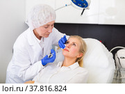 Cosmetologist doing botulotoxin injections for young woman. Стоковое фото, фотограф Яков Филимонов / Фотобанк Лори