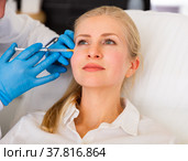 Cosmetologist doing botulotoxin injections for young woman. Стоковое фото, фотограф Яков Филимонов / Фотобанк Лори