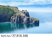 Baikal Lake on a June afternoon. View of the rocky cape Three Brothers - a popular place for tourists on the island of Olkhon. Natural background. Summer holidays and travel. Стоковое фото, фотограф Виктория Катьянова / Фотобанк Лори