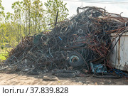 Copper cables for reworking. Processing industry, a pile of old scrap metal, ready for recycling. Scrap metal recycling. Scrap copper cable for reworking. Processing industry, a pile of old scrap. Стоковое фото, фотограф Руслан Лесков / Фотобанк Лори