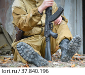 Вооружённый доброволец после боя. Специальные военные ботинки.  Солдат с автоматом. Стоковое фото, фотограф Виталий Михайлюк / Фотобанк Лори