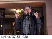 Актер Евгений Князев во время уличного концерта, посвященного закрытию 101-ого сезона Государственного академического театра им. Евгения Вахтангова, на улице Арбат в центре города Москвы, Россия (2022 год). Редакционное фото, фотограф Николай Винокуров / Фотобанк Лори