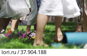 Women in traditional clothing dancing on the grass with bare feet during folk festival. Стоковое видео, видеограф Константин Шишкин / Фотобанк Лори