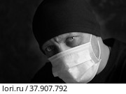 Молодой мужчина в медицинской маске. Прямой взгляд доктора, трагичное фото. Стоковое фото, фотограф Виталий Михайлюк / Фотобанк Лори