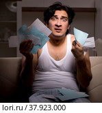 The young man calculating expences night at home. Стоковое фото, фотограф Elnur / Фотобанк Лори