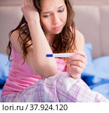 Woman upset with pregnancy test results. Стоковое фото, фотограф Elnur / Фотобанк Лори