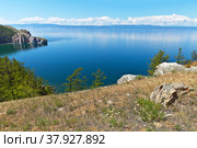 Baikal Lake. A calm landscape of the coast of Olkhon Island on a sunny summer day. View on Small Sea Strait and Sagan-Hushun Rock. Natural background. Summer vacation and travel. Стоковое фото, фотограф Виктория Катьянова / Фотобанк Лори