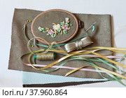 Embroidery with satin and nylon ribbons on colored fabric and accessories for embroidery: ribbons, threads, needles, pins and pieces of tissue  (Embroidery with satin ribbons were performed by author of the images) Стоковое фото, фотограф Виктория Катьянова / Фотобанк Лори