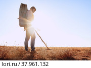 Man with metal detector equipment searching for metal goods in the field. Стоковое фото, фотограф Сергей Толмачёв / Фотобанк Лори