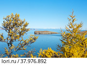 Baikal Lake in October. Beautiful coast of Olkhon Island on a sunny autumn day. View of the Small Sea Strait and Kharantsy Islet. Natural background. Стоковое фото, фотограф Виктория Катьянова / Фотобанк Лори