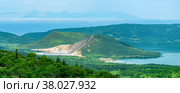Landscape of Kunashir Island, lakes and lava domes in the center of Golovnin volcano caldera; the island of Hokkaido is visible in the distance in the sea. Стоковое фото, фотограф Евгений Харитонов / Фотобанк Лори