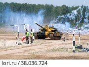 ALABINO, RUSSIA - AUGUST 19, 2022: Tajik team tank on the tank biathlon track on the Alabino training ground. International Army Games. Редакционное фото, фотограф Виктор Карасев / Фотобанк Лори