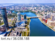 Aerial view of central part of modern city with skyscrapers and residential buildings. River and bridge on summer day. Yekaterinburg. Russia (2022 год). Стоковое фото, фотограф Евгений Ткачёв / Фотобанк Лори