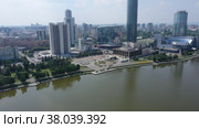 Aerial view of central part of modern city with skyscrapers and residential buildings. River and bridge on summer day. Yekaterinburg. Russia. Стоковое видео, видеограф Евгений Ткачёв / Фотобанк Лори