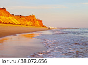Beautiful Praia da Falesia near the city of Vilamoura with a shallow sandy beach fringed with unusual red rocks at sunset. Algarve, Portugal. Natural background. Summer holiday by the sea (2012 год). Стоковое фото, фотограф Виктория Катьянова / Фотобанк Лори