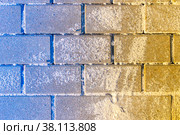 Blue-yellow hailstone superimposed on stacked paving slabs sprinkled with sand. Стоковое фото, фотограф Дмитрий Коростылев / Фотобанк Лори