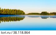 Nice panoramic view of Lake Haukivesi during sunrise. Light fog over the water. Specular reflection in the water. Стоковое фото, фотограф Михаил Аккуратoв / Фотобанк Лори