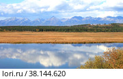 Beautiful autumnal landscape with reflection in the River of blue sky with fast flying clouds. Siberia, Buryatia, Tunka Valley. Natural autumn background, time lapse. Стоковое видео, видеограф Виктория Катьянова / Фотобанк Лори