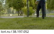 Inspector in business suit checking the manhole cover in the park. Стоковое видео, видеограф Chudakov_Ivan / Фотобанк Лори