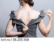 Young woman unzips the zipper on the dress. Hand showing fuck sign. Стоковое фото, фотограф Сергей Пристяжнюк (Serg Zastavkin) / Фотобанк Лори