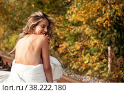 Young emotional pretty woman in her bed on railway tracks. Single female dreams in nature. Concept of problem of travel ban and inability to move. Stay at home. Copying space for site. Стоковое фото, фотограф Aleksandr Golubev / Фотобанк Лори