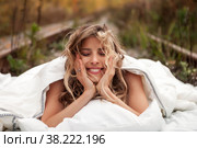 Young emotional pretty woman in her bed on railway tracks. Single female dreams in nature. Concept of problem of travel ban and inability to move. Stay at home. Copying space for site. Стоковое фото, фотограф Aleksandr Golubev / Фотобанк Лори