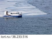Baikal Lake on an April day. Top view of an all-terrain vehicle Hivus carrying passengers to Olkhon Island during the spring ice drift. Natural background. Unusual travel. Стоковое фото, фотограф Виктория Катьянова / Фотобанк Лори