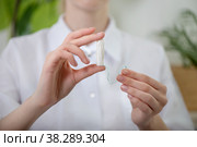 Woman in medical uniform with tampon in hand. Menstruation and hygiene concept: monthlies, women periods. Close-up, selective focus. Стоковое фото, фотограф Юлия Тарасова / Фотобанк Лори