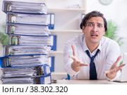 Young male employee unhappy with excessive work. Стоковое фото, фотограф Elnur / Фотобанк Лори