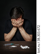 Man in despair from drug addiction. Стоковое фото, фотограф Okssi / Фотобанк Лори
