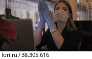 Girl Slavic appearance in medical mask and rubber gloves works with computer-laptop. Стоковое видео, видеограф Aleksandr Golubev / Фотобанк Лори