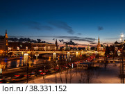 Evening winter Moscow at sunset. View of the Moskvoretskaya embankment, the Moskva River and the Bolshoy Moskvoretsky Bridge. Russia (2018 год). Стоковое фото, фотограф Наталья Волкова / Фотобанк Лори