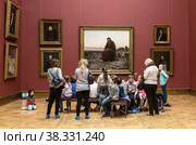 Children in the hall of the famous 19th-century Russian artist Ivan Kramskoy in front of his painting "Christ in the Desert" at the Tretyakov Gallery. Moscow, Russia (2018 год). Редакционное фото, фотограф Наталья Волкова / Фотобанк Лори