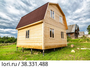 New small wooden house under construction at the village. Стоковое фото, фотограф FotograFF / Фотобанк Лори