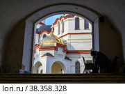 NEW ATHOS, ABKHAZIA - 27 JANUARY, 2022: A monk paints pictures at the entrance to the New Athos Simone-Kananite Monastery in Abkhazia, founded in 1875 and consecrated in 1900. Редакционное фото, фотограф Сергей Фролов / Фотобанк Лори