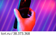 Sofia, Bulgaria-05 11 2022: vertical video hand holding phone with green screen abstrack neon floral background. Стоковое видео, видеограф Mihail Mihaylov / Фотобанк Лори
