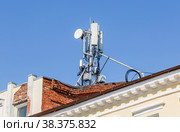 Telecommunication tower for mobile phone with antennas on a roofe. Стоковое фото, фотограф FotograFF / Фотобанк Лори