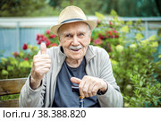 Portrait of a smiling and confident senior 87 years old cute in a hat with a mustache. Happy active old age. Стоковое фото, фотограф Оксана Медведева / Фотобанк Лори