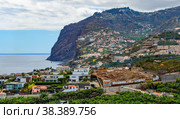 MADEIRA, PORTUGAL - JULY  11, 2012: The fishing village of Camara de Lobos and Cabo Gigao rock. Стоковое фото, фотограф Михаил Аккуратoв / Фотобанк Лори