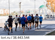 Marathon race. Marathon race of people athletes on the road in the city park. Running people at marathon competitions. Gorky Park, Moscow, Russia, September 2022. Редакционное фото, фотограф Photojuli / Фотобанк Лори