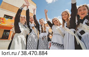 Happy Russian school graduates are stretching their hands on their last school day. Стоковое фото, фотограф Mikhail Davidovich / Фотобанк Лори