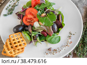 Salad diet for weight correction from the leaves of Lollo Rosso lettuce, watercress salad and other green herbs with tomatoes, olives and fitaki. Close up. Стоковое фото, фотограф Оксана Медведева / Фотобанк Лори